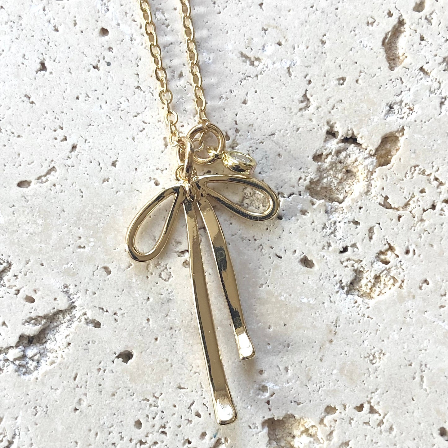 Melted droopy ribbon bow charm necklace