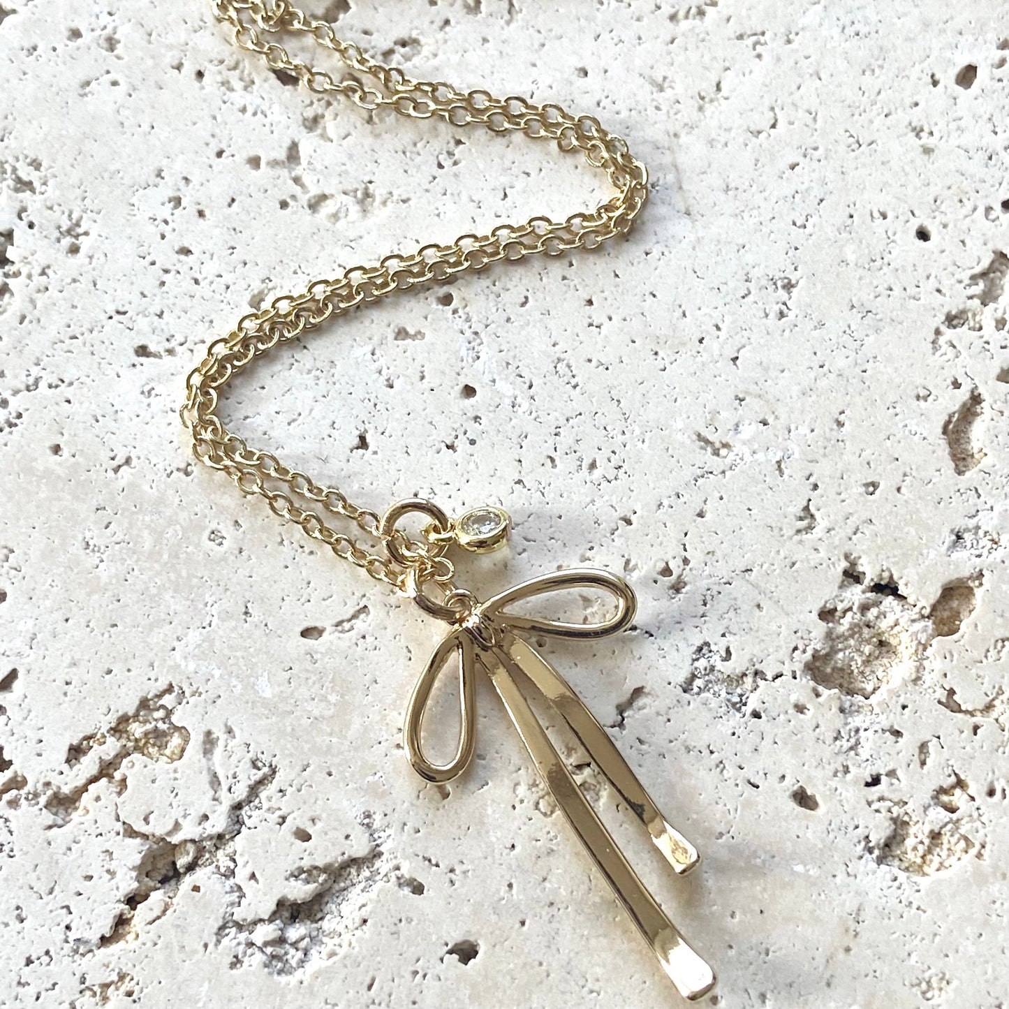 Melted droopy ribbon bow charm necklace